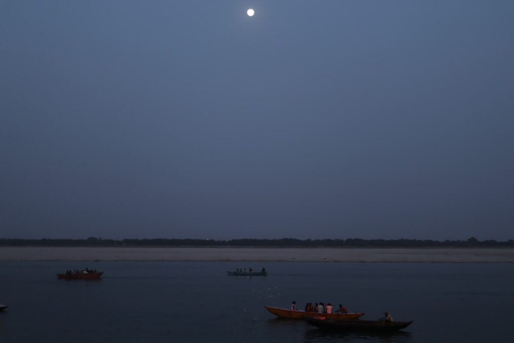 Varanasi ghat photography with boats, moon and ganga river