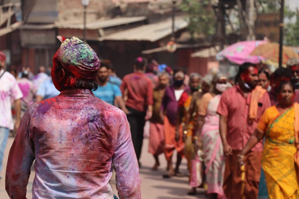 Street photography of a people celebrating Holy with beautiful colors in Varanasi and Street photography for beginners