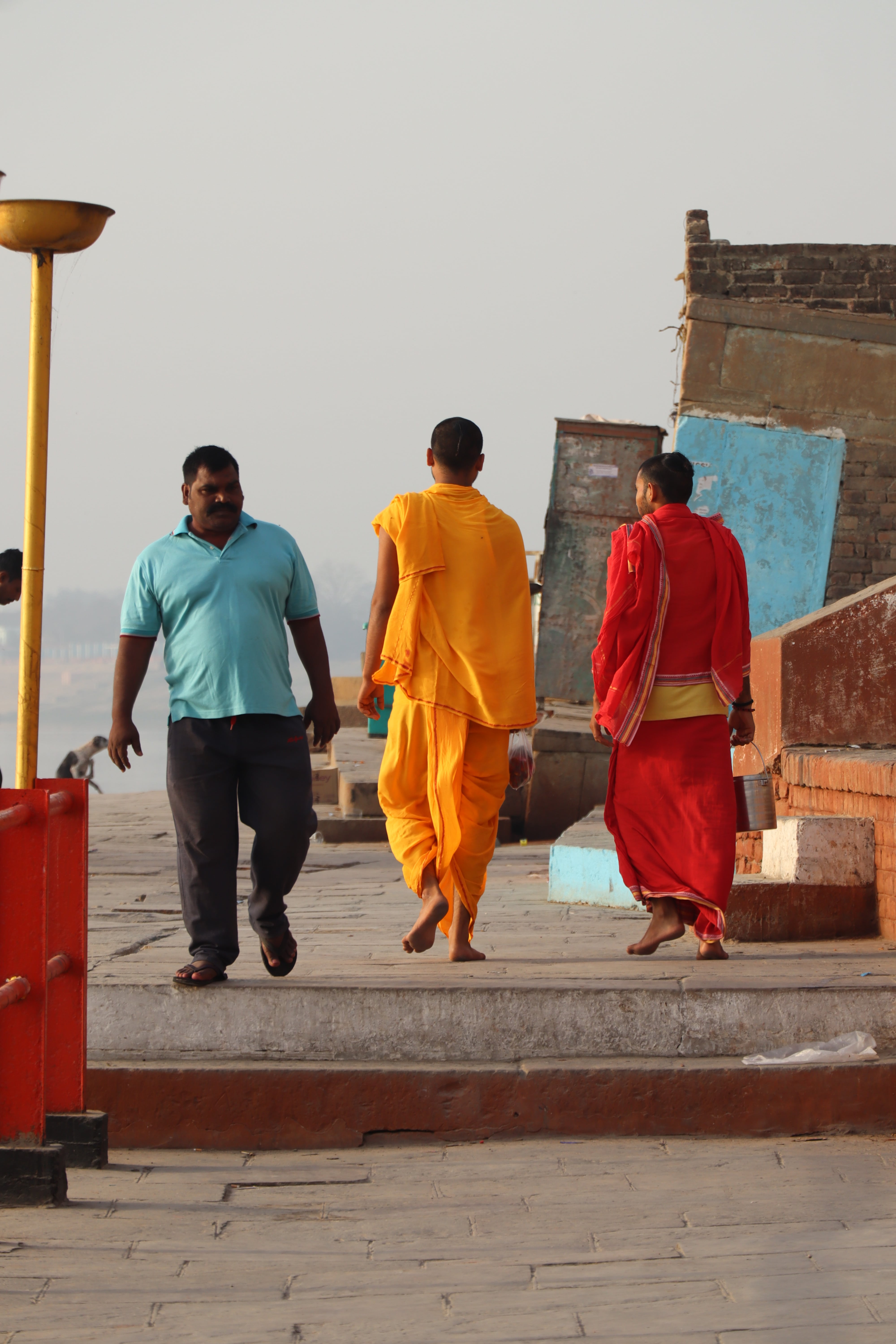 Candid photography of three men with colorful dress in Varanasi ghat