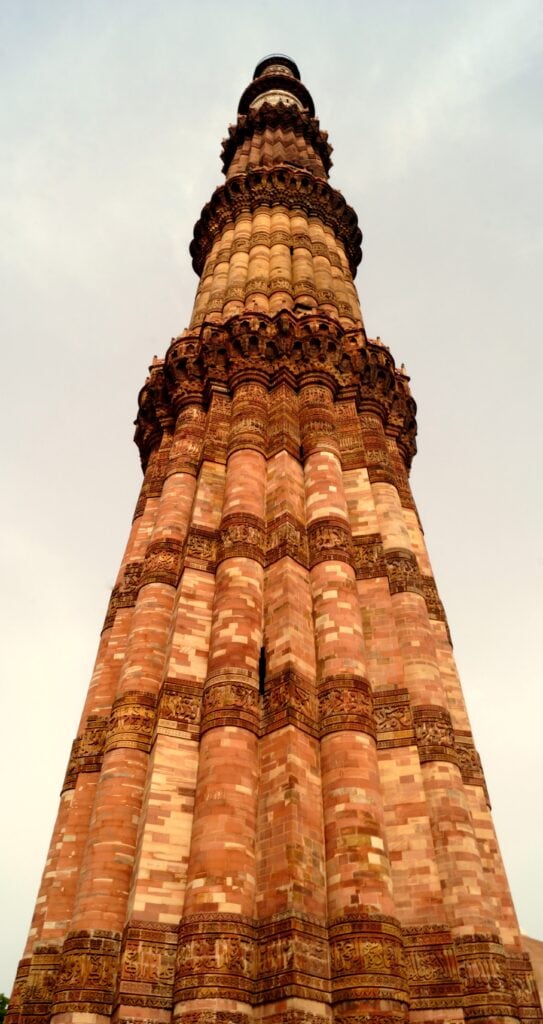 photography of upper storey of Qutb Minar and complex